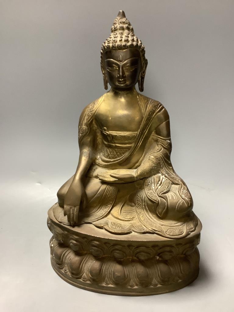 A bronze figure of a seated Buddha and a Japanese blue and white ovoid vase, of 'sack' form with applied tied cord and wavy rim, tallest 31cm H 30cm & 23cm